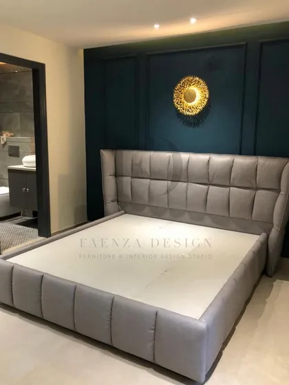 A modern bed with a winged, grid-tufted headboard in a cool grey fabric. The clean lines and contemporary design make it a perfect fit for a stylish, minimalist bedroom.
