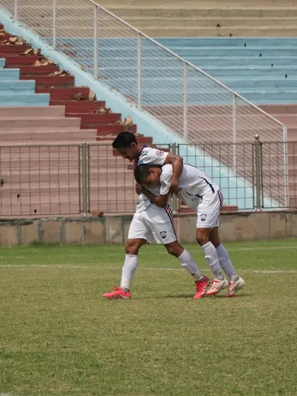 Two players celebrating a crucial moment in the match. Teamwork makes the dream work.