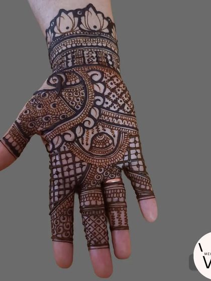 A beautiful Indian mehndi design with a lotus cuff.