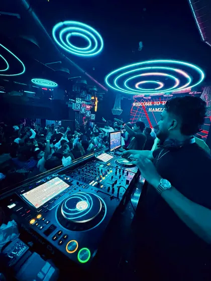 In the zone, surrounded by neon lights and the energy of the crowd. This is where I feel most at home, mixing live and reading the room to play the perfect track at the perfect moment.