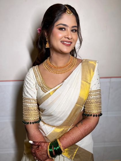 Another angle of the complete look, showing how the soft glam makeup works beautifully with the traditional jewelry and attire.