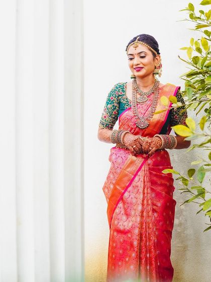 A full-length shot of Rakshita against a simple white backdrop, letting her bridal look be the star.