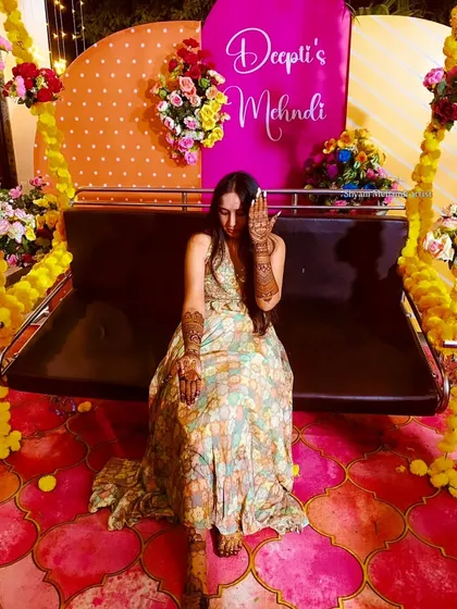 A playful shot of the bride from the previous image, showing off her palm design.