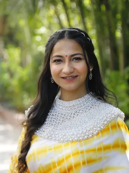 A close-up of the elegant Haldi look, showing the simple braided hairstyle and the radiant, natural makeup.