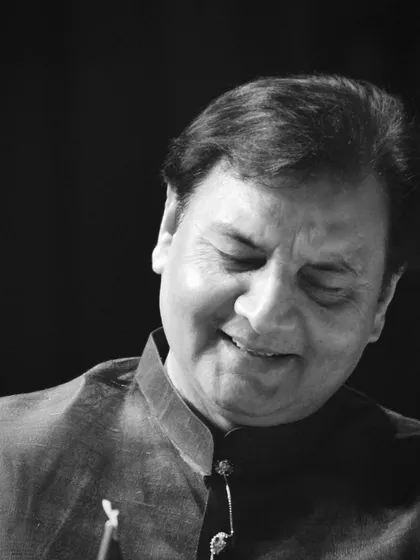 A black and white portrait capturing a moment of quiet satisfaction during a performance.