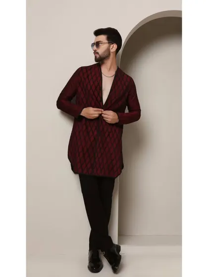 The 'Maroon Regalia' kurta features a stunning diamond-cut pattern with meticulous black pintucks. The V-neckline adds a modern touch to this classic, sophisticated piece.