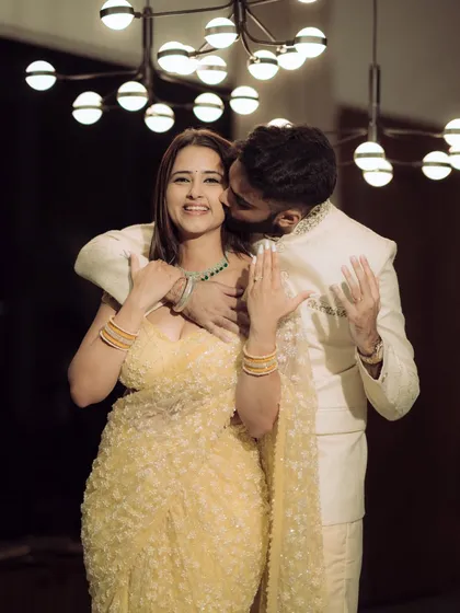 A moment of pure joy and laughter during an indoor engagement celebration. The warm lighting and genuine expressions make this a perfect blend of candid emotion and cinematic style.