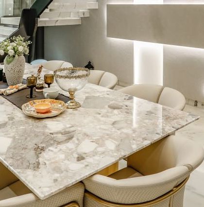 A close-up of the beautifully set dining table, made from a unique piece of terrazzo-style marble.