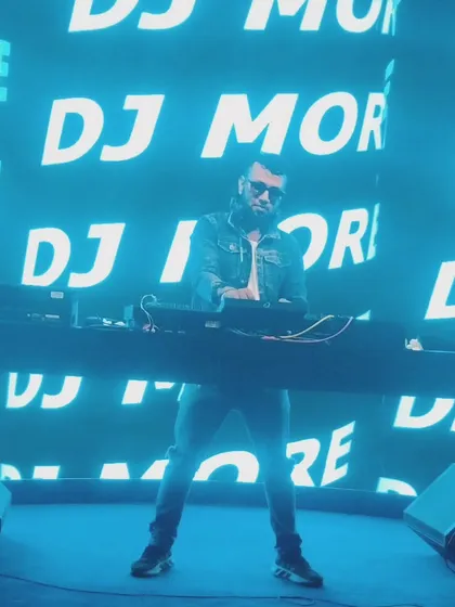 In my element, commanding the stage with my name up in lights. This is the energy and presence I bring to large-scale events, making sure every beat hits with maximum impact.