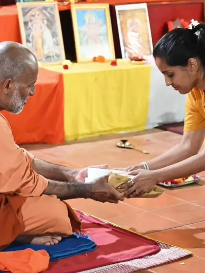 The act of giving and receiving Prasad, a blessed offering, is a moment of connection between teacher and student.