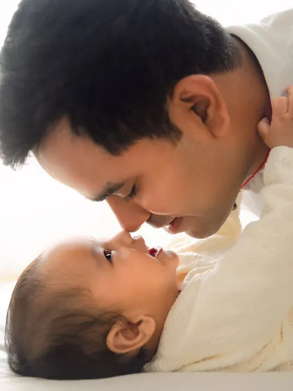 A father and baby share a gentle nose-to-nose moment. These quiet, intimate portraits are incredibly powerful and full of emotion.
