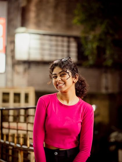A bright, happy smile captured at night. This shows that night photography can be vibrant and full of positive energy.