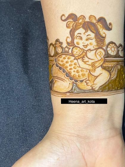 A close-up of a cute baby girl portrait on the wrist, created for a baby shower. This kind of detailed character work is something we love to do to make your design unique.