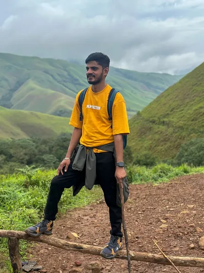 Posing for a photo on the trail, with the beautiful rolling hills of Kudremukha in the background. Every spot is a photo opportunity.