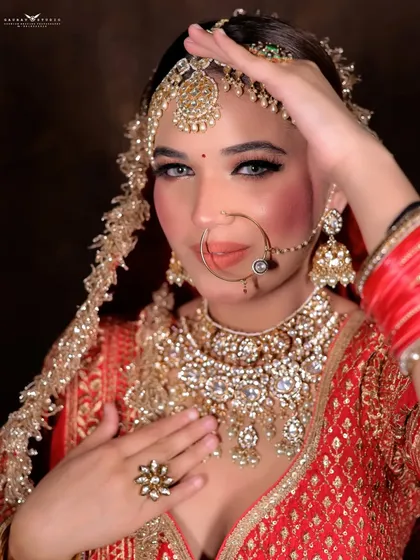 A confident portrait with the bride's hand raised, showcasing her regal bearing.
