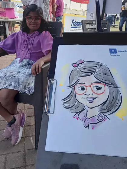 A young guest enjoying the live caricature service at a Bajaj Allianz family day event. My art is suitable for all ages, making it perfect for corporate family functions.