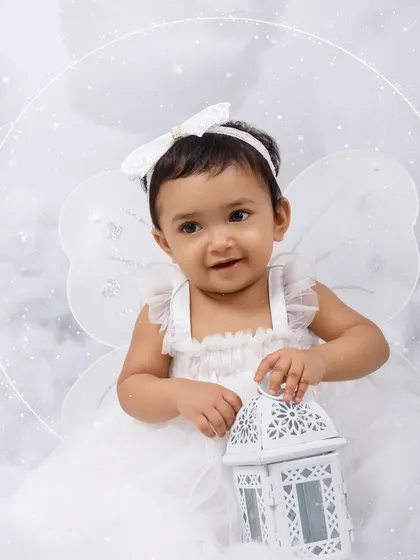 A beautiful close-up of a little angel holding a lantern, with a halo effect adding to the magic.