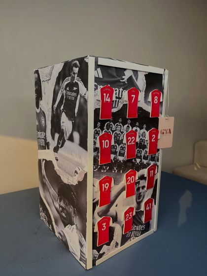For the football fan, this gift was wrapped in a custom black-and-white collage of Arsenal players, with miniature jerseys representing key team members. It's an example of how I incorporate personal passions into my designs.