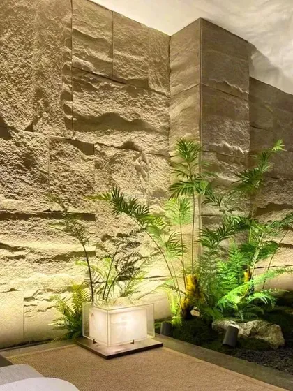 An elegant installation of our light-colored PU stone panels in a hallway, complemented by plants and soft lighting to create a serene, zen-like atmosphere.