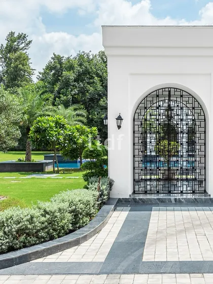 A close-up view of the elegant arches and intricate metal latticework of the farmhouse. This detail showcases our commitment to craftsmanship and our ability to blend classical charm with modern minimalism.
