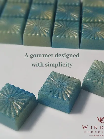 An example of my artistic approach to chocolate making. These gourmet bonbons are colored with cocoa butter to create a beautiful blue shimmer, proving that chocolate can be both delicious and a work of art.