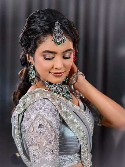 A portrait shot showing the beautiful details of the embroidered blouse and makeup.