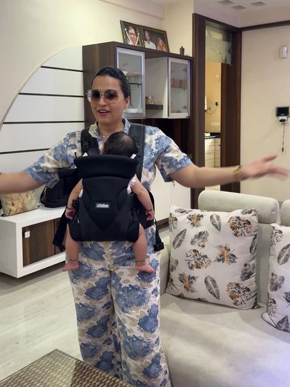 This shot from the LittleBum campaign shows the baby carrier in an indoor home setting. It demonstrates the product's versatility, showing that it's just as useful for getting things done around the house as it is for being out and about.