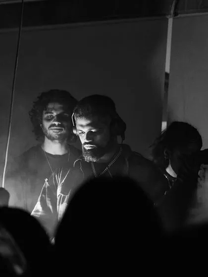A moody, black and white shot with fellow artists, capturing the camaraderie behind the scenes.