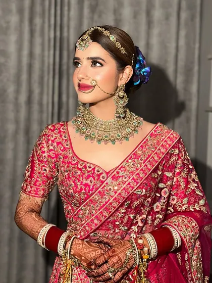 A closer look at this bride's regal profile. The bold lip and defined eyes are balanced with glowing skin, creating a look of pure elegance.