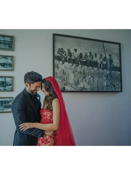 A quiet moment between Shibani and Farhan, with the iconic 'Lunch atop a Skyscraper' photo in the background. It’s a creative portrait that feels like a story within a story.