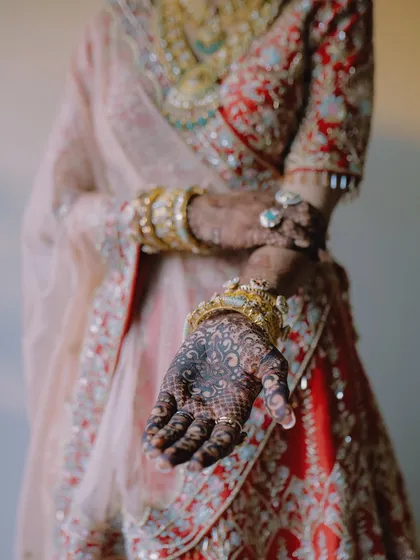 A detailed shot of the bride's intricate Mehendi design. We understand the importance of capturing these artistic details that are a significant part of the bridal look.