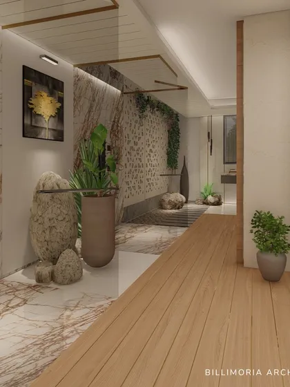 This open-layout bathroom brings the outdoors in with natural stone, wood flooring, and abundant plants. The design creates a seamless transition between the indoor and a semi-outdoor pebble-floored area.