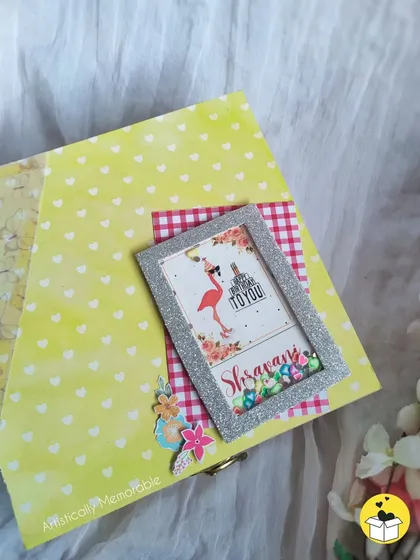 A close-up of the personalized hamper box lid, showing the glittery frame and floral details.