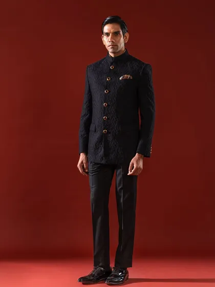 The quintessential Bandhgala, presented in a deep, textured black. This ensemble is the epitome of sharp, modern royalty, featuring a flawless bespoke fit and ornate buttons that provide a touch of classic distinction for any formal occasion.