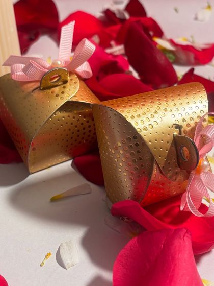 A simple yet elegant gift for Chocolate Day. These are my handmade heart shaped chocolates, presented in a beautiful golden pouch tied with a pink ribbon.