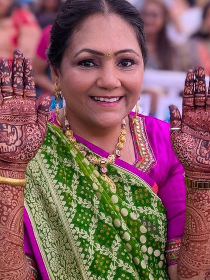 Another happy client proudly displaying her intricate mehndi. The design features elephants and traditional patterns, and the stain is beautifully dark.