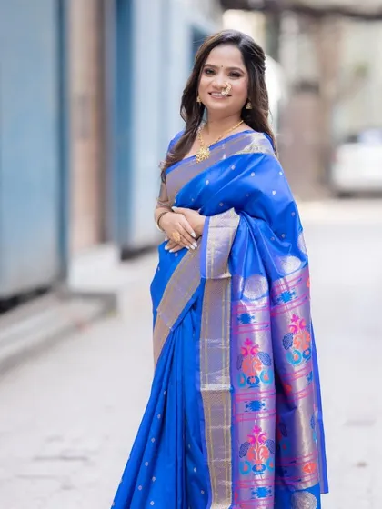 A full-length shot of the bride in her beautiful blue Paithani saree for her engagement. The makeup is kept classic and elegant to suit the traditional attire.
