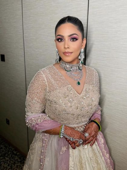 A sleek high ponytail transitioning into a bun for a modern engagement look.