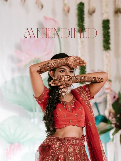 "Mehendified." A playful and stylish shot of the bride showing off her intricate Mehendi design. This captures the fun and beauty of pre-wedding rituals.