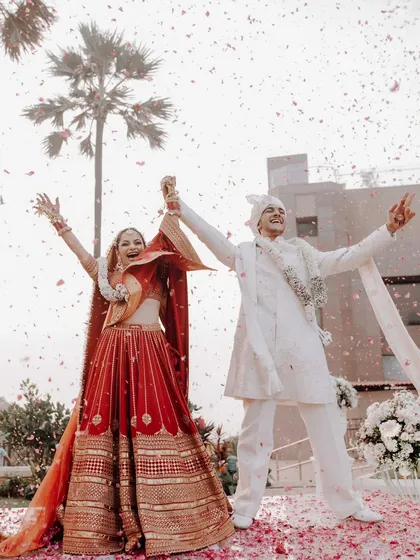 A moment of pure celebration as the couple is showered with petals after their wedding ceremony. We focus on creating these joyful, picture perfect memories for you and your family.