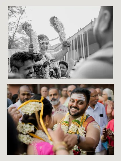 The varmala or garland exchange ceremony, captured in a dynamic black and white shot that focuses on the couple's happy expressions.