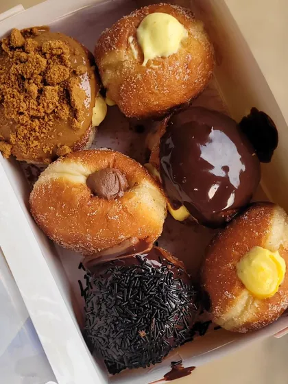 Can't decide which one to try? My Ultimate Box is the perfect solution. It's an assortment of my bestseller bombolinis, including Biscoff Crunch, Double Chocolate Boston Creme, and seasonal fruit specials like Fresh Mango Custard.