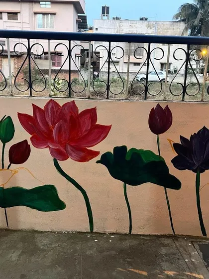 This serene lotus mural transformed a simple compound wall at my home. I used a mix of bold reds and deep purples alongside delicate outlines to show the flowers in different stages of bloom, creating a peaceful and beautiful atmosphere.