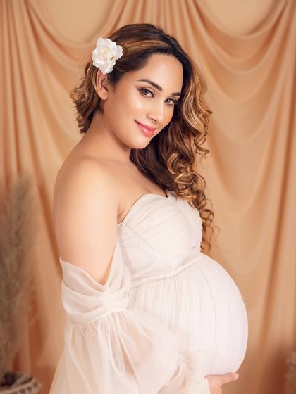 A glowing close-up portrait, with a simple flower in her hair adding a touch of natural beauty.