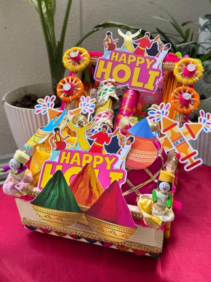 Our premium Holi hamper, priced at ₹1200, is packed in a beautifully decorated cart. It’s filled with premium snacks, drinks, and everything you need for a fantastic celebration.