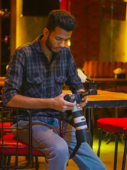 Checking my camera settings between shots at a club shoot, ensuring everything is perfect for the next take.