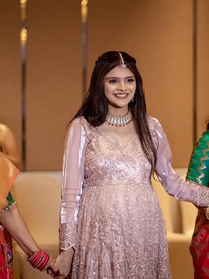 The bride making her entrance, holding hands with the women of her family. A beautiful moment of love and support.
