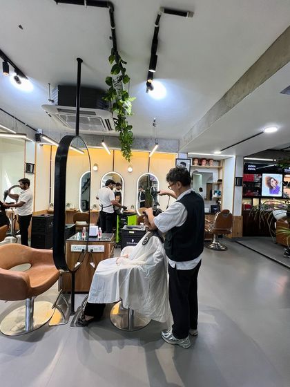 A stylist working on a short haircut, showcasing the precision and artistry that goes into every service.