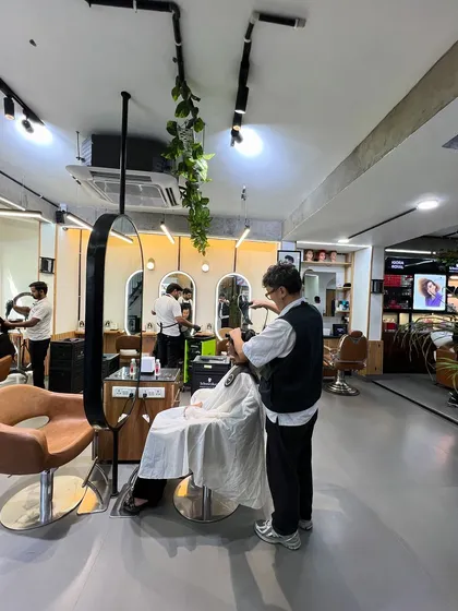 A stylist working on a short haircut, showcasing the precision and artistry that goes into every service.