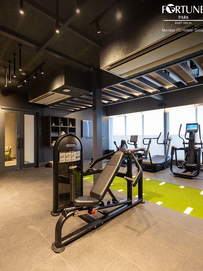 My cardio section includes treadmills and elliptical trainers, situated next to a turf track for functional training. The large windows provide natural light to energize your workout.